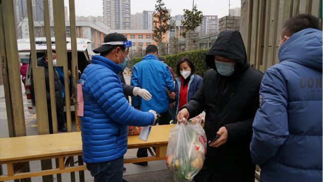 Residents line up to buy vegetables at a gated community in Xi'an, Shaanxi Province, China on December 31, 2021.  It was the ninth day that the lockdown was imposed in the communities (villages) and units in the xi'an.