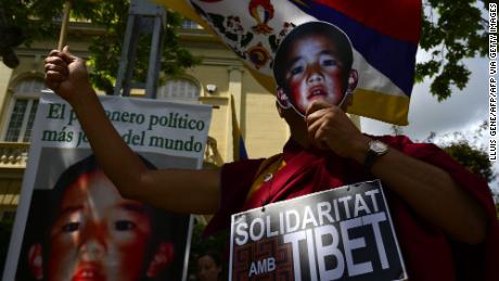 Pro-Tibetan protestors hold picures of Gendun Cheokyi Nyima (recognized by the Dalai Lama as the 11th Panchen Lama) during a demonstration outside the Chinese consulate in Barcelona on May 17, 2013.