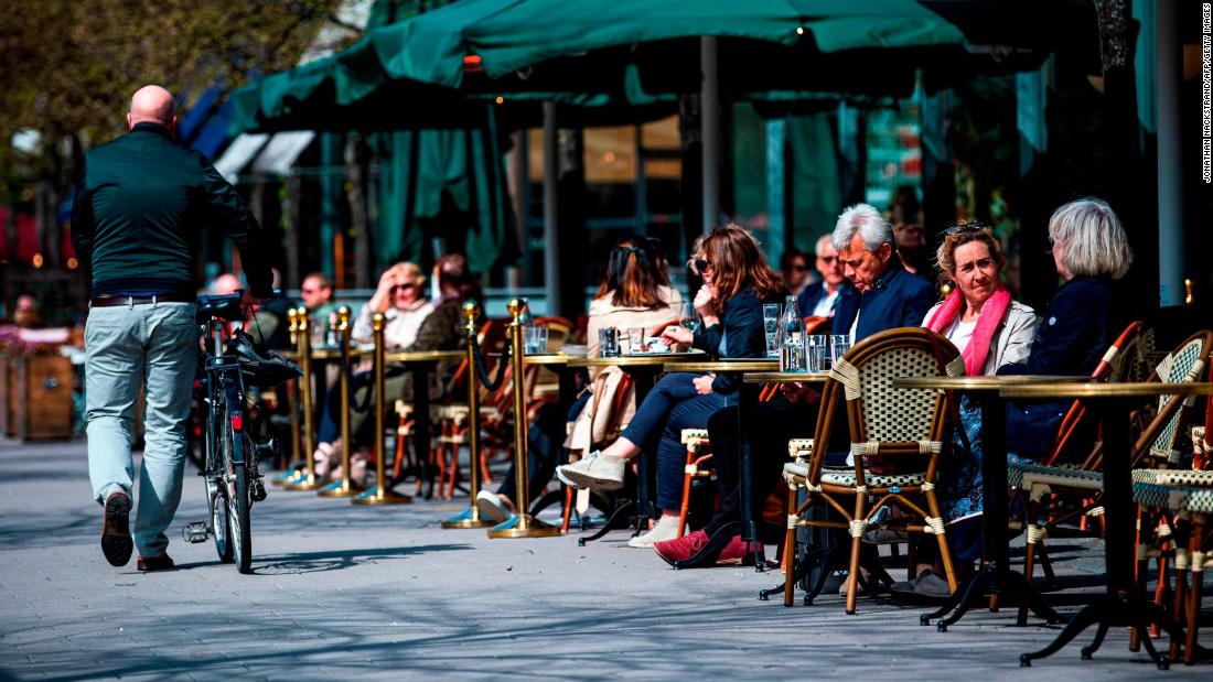People sit in a restaurant in Stockholm on May 8, 2020, during the coronavirus pandemic.