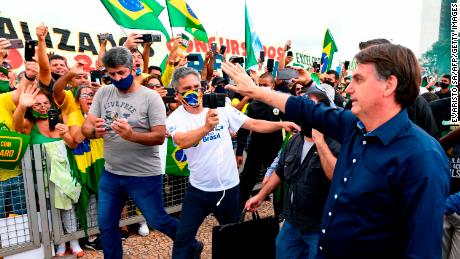 Brazilian President Jair Bolsonaro greets supporters on May 24. 
