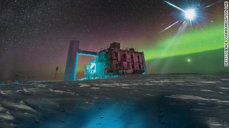 In this artistic rendering, based on a real image of the IceCube Lab at the South Pole, a distant source emits neutrinos which are detected under the ice by the IceCube sensors.