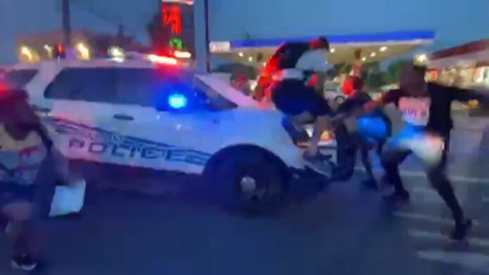 Video appears to show Detroit police car driving into protesters