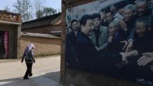 This photo taken in September 2017 shows A billboard featuring a photo of China&#39;s President Xi Jinping visiting residents in Zhangzhuang village in Lankao in China&#39;s central Henan province. 