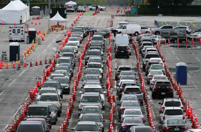 Cars line up as drivers wait to be tested for Covid-19 at the Hard Rock Stadium parking lot in Miami Gardens, Florida, on July 6.