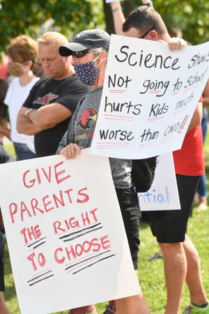 Parents and students held a Back-to-School rally for families who want the schools to open in Franklin, Tenn. Tuesday, Aug. 4, 2020 