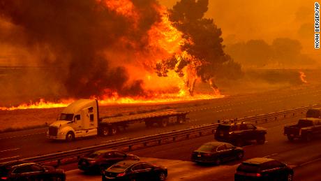 Flames from the LNU Lightning Complex fires jump Interstate 80 in Vacaville, California.