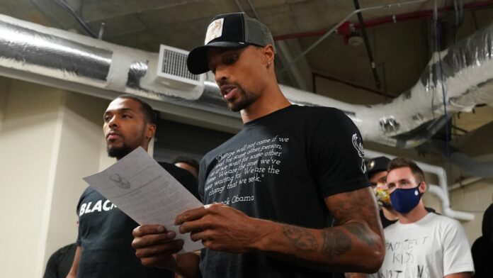Milwaukee Bucks guard George Hill reads a statement following the players&#39; decision to boycott their playoff game against the Orlando Magic