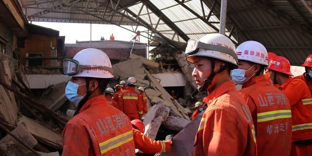 Rescuers search for victims in the aftermath of the collapse of a two-story restaurant in Xiangfen county in northern China's Shanxi province on Saturday, Aug. 29, 2020. (Chinatopix Via AP)