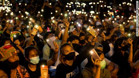 Students and anti-government protesters light up their phones at Democracy Monument on August 16, 2020 in Bangkok.