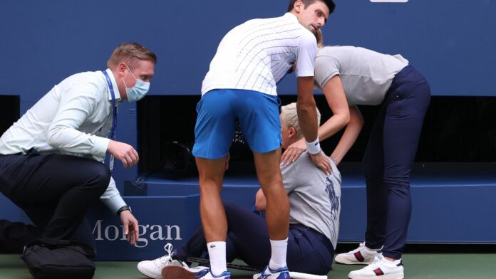The line judge is seen on the ground after the incident