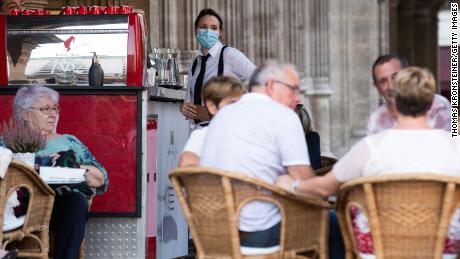 A waitress in Vienna wears a face mask in accordance with the new, stricter rules imposed by the Austrian government on September 14.