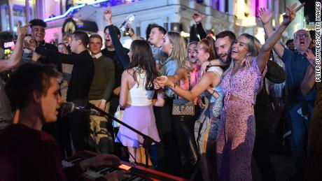 People are spotted dancing on a baker in Leicester Square in central London on September 12, just days before the ban on social gatherings again.