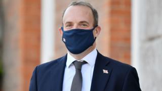 Foreign Secretary Dominique Rabe, wearing a face mask, waits for the French and German foreign ministers to arrive for the E3 ministerial meeting at Chevening House in Kent's Seven Aux.