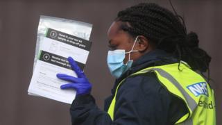 The NHS test and trace worker has self-testing kits at a testing center in Bolton