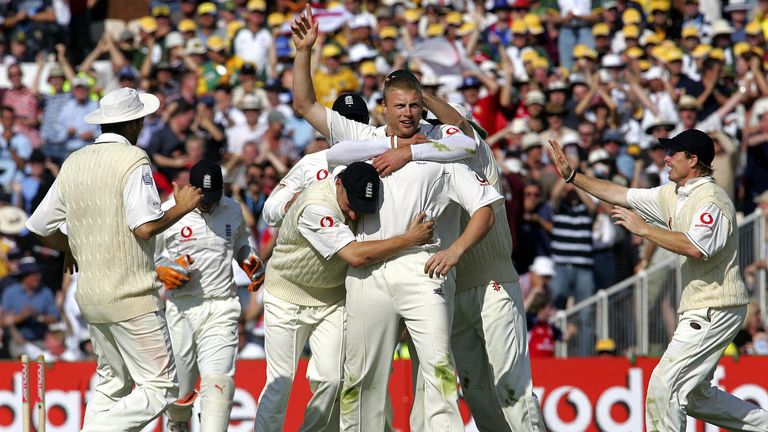 Manchester, United Kingdom: England players congratulate Australian Andrew Flintoff (C) on August 12, 2005 at Old Trafford Cricket Ground in Manchester on the second day of the third Ashes Test after dismissing Australian batsman Simon K. Kat Teach.