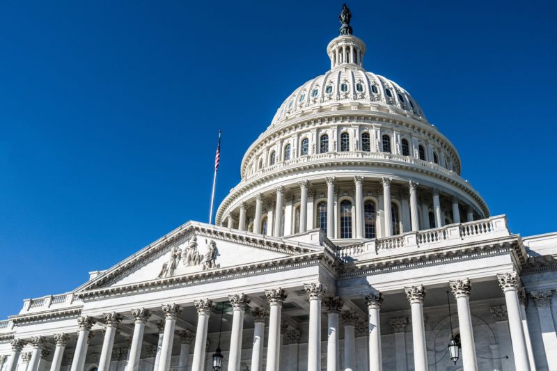 The dome of the United States Capitol in front of the blue sky in Washington DC.