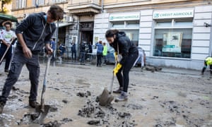 People clean up after a flood in Ventimiglia, northern Italy