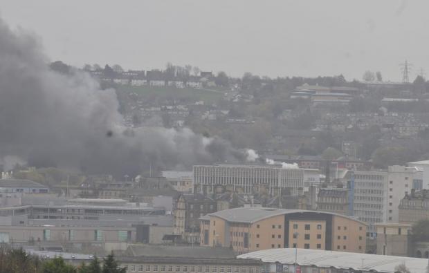 Bradford Telegraph and Argus: Smoke continues to rise over Bradford this afternoon