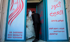 Palestinian groom Ahmed Omar Khallah put on his veil from a beauty salon in the northern Gaza Strip.