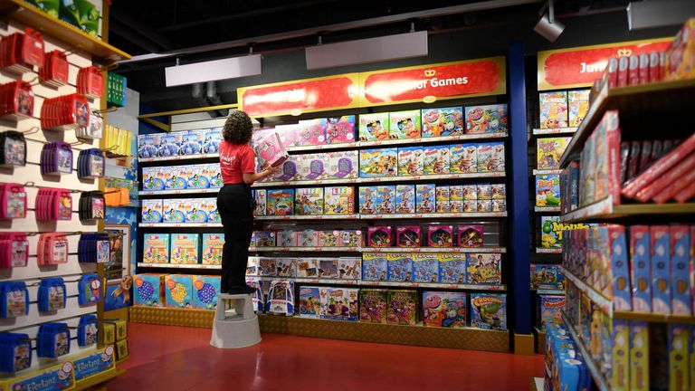 A shop assistant stacks toys on the shelves at Hamleys Toy in central London on October 15, 2020.  (Photo by Justin Tellis / AFP) (Photo by Justin Tellis / AFP)