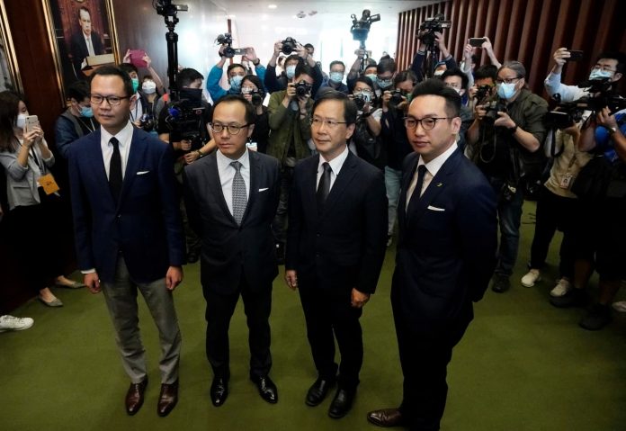 Hong Kong fires pro-democracy lawmakers as China protests


