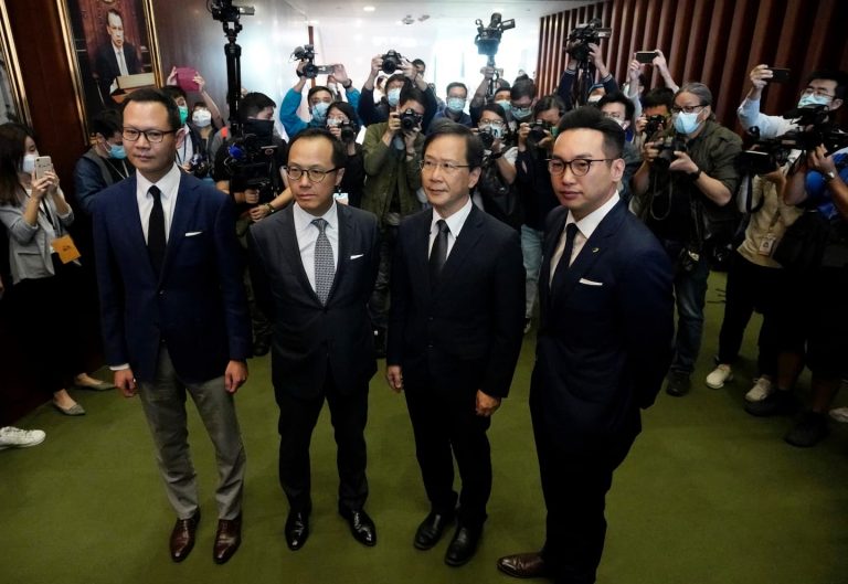 Hong Kong fires pro-democracy lawmakers as China protests