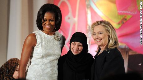 The then U.S.  During a ceremony with First Lady Michelle Obama, the recipient of the 2017 International Women's Courage Award, Summer Badwi, and then U.S.  Secretary of State Hillary Clinton.