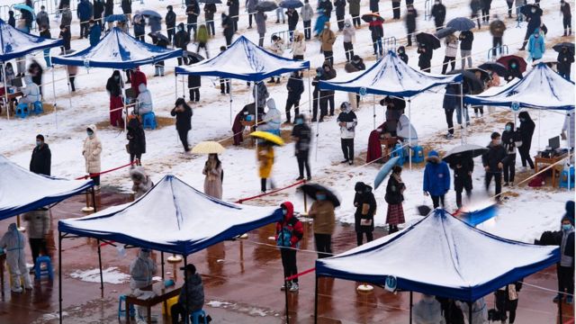 Aerial view of students and teachers queuing for a COVID-19 nucleic acid test at Northwestern Polytechnical University during snowfall in Xi'an, Shaanxi Province, China, on December 25, 2021