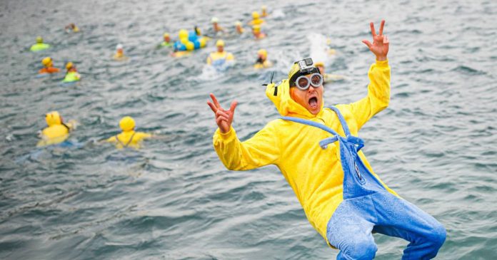 Thousands of swimmers brave unusual cold for traditional 